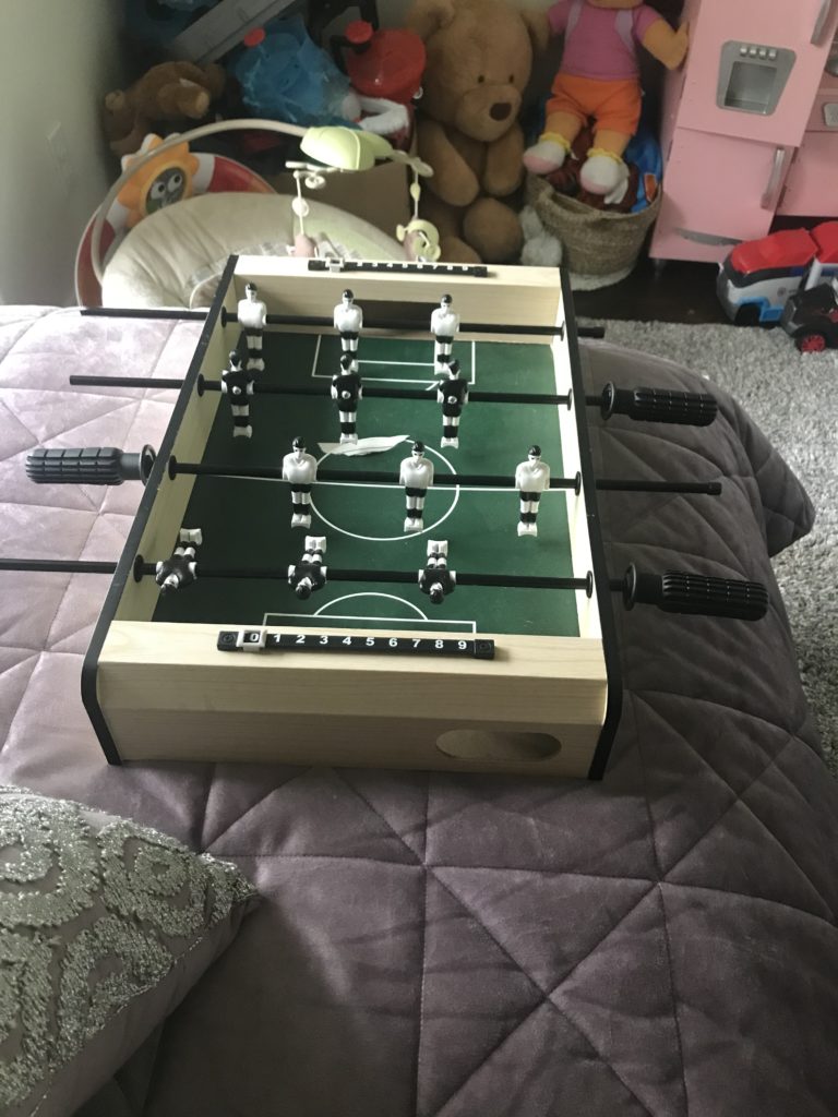 Picture of a small foosball table game.