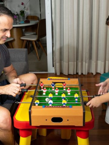 Picture of father and son playing foosball.