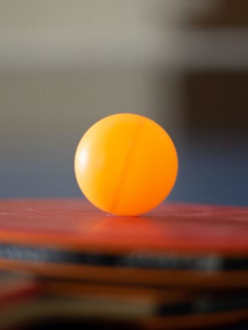 Picture of a ping pong ball on a paddle,