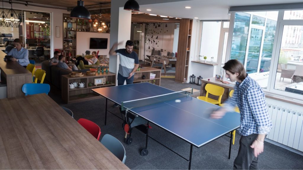 Picture of men playing game with ping pong accessories,