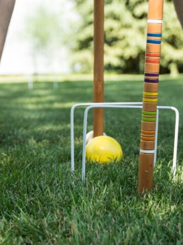 Picture of a person playing croquet.
