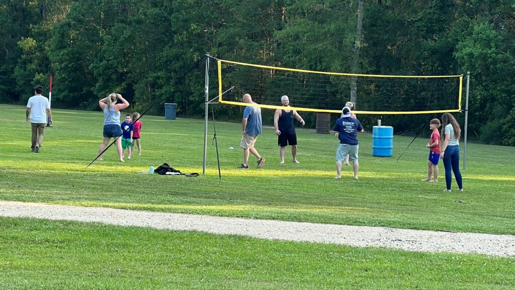 Picture of a family playing volleyball at a family reunion.