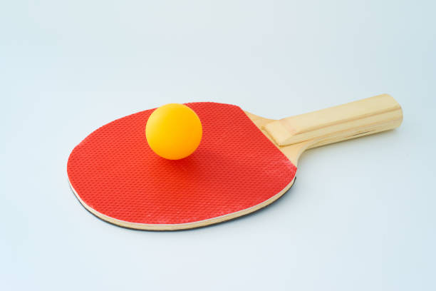 Pin-pong rubbers and a ball on white background .