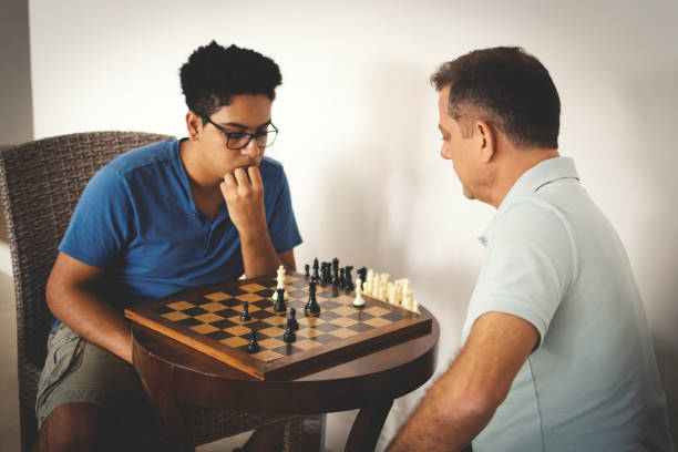 Father and son playing chess.