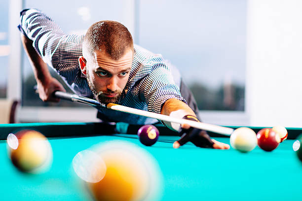 An image of a person playing a billiard game.